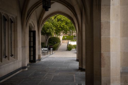 Free A serene view of an arched walkway leading to a garden area on the UCLA campus in Los Angeles. Stock Photo