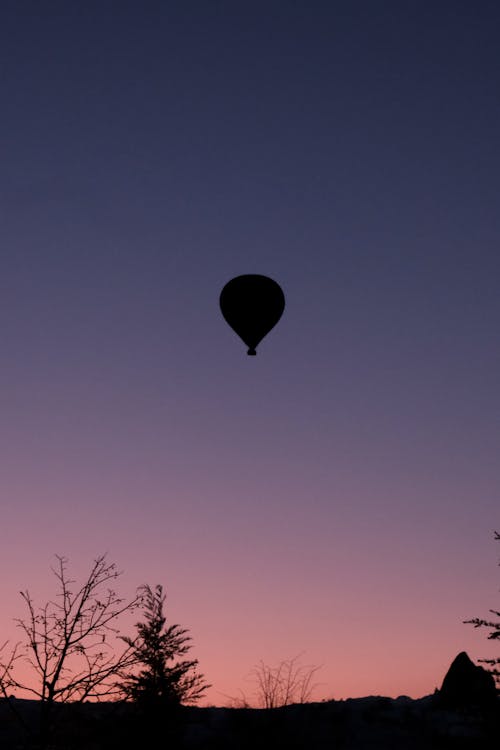 Silhouetted Hot Air Balloon in the Air at Sunset 