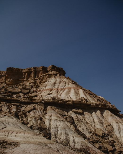 Explore the rugged sandstone formations of Bardenas Reales in Aragon, Spain, under a clear blue sky.