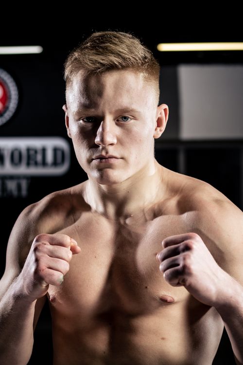 Free Intense portrait of a young martial artist in a fighting stance, showing focus and strength. Stock Photo
