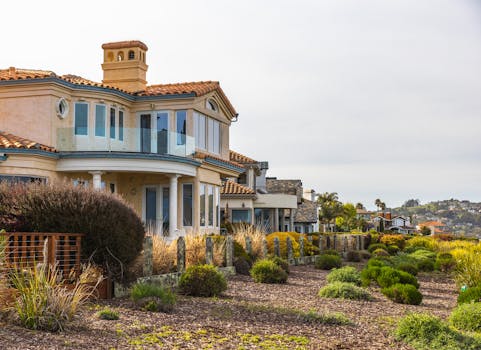 Beautiful coastal villa surrounded by lush greenery and scenic views.