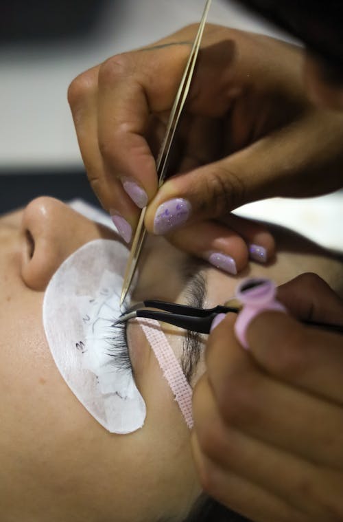 Woman Doing Lashes at Beautician