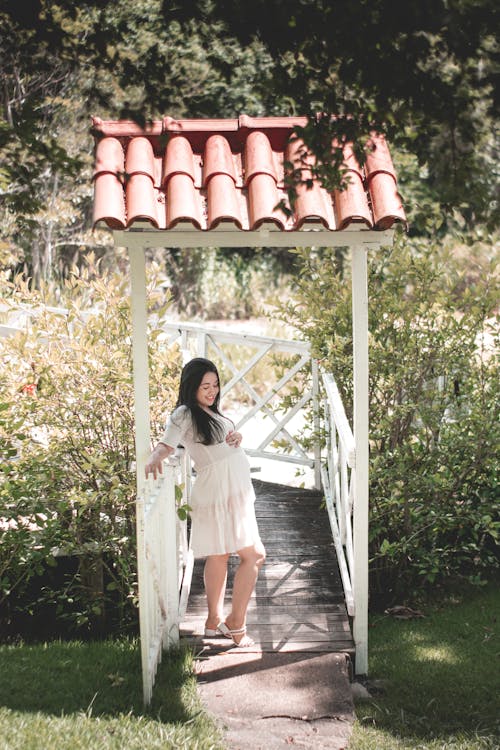 Woman in White Dress Posing in Garden