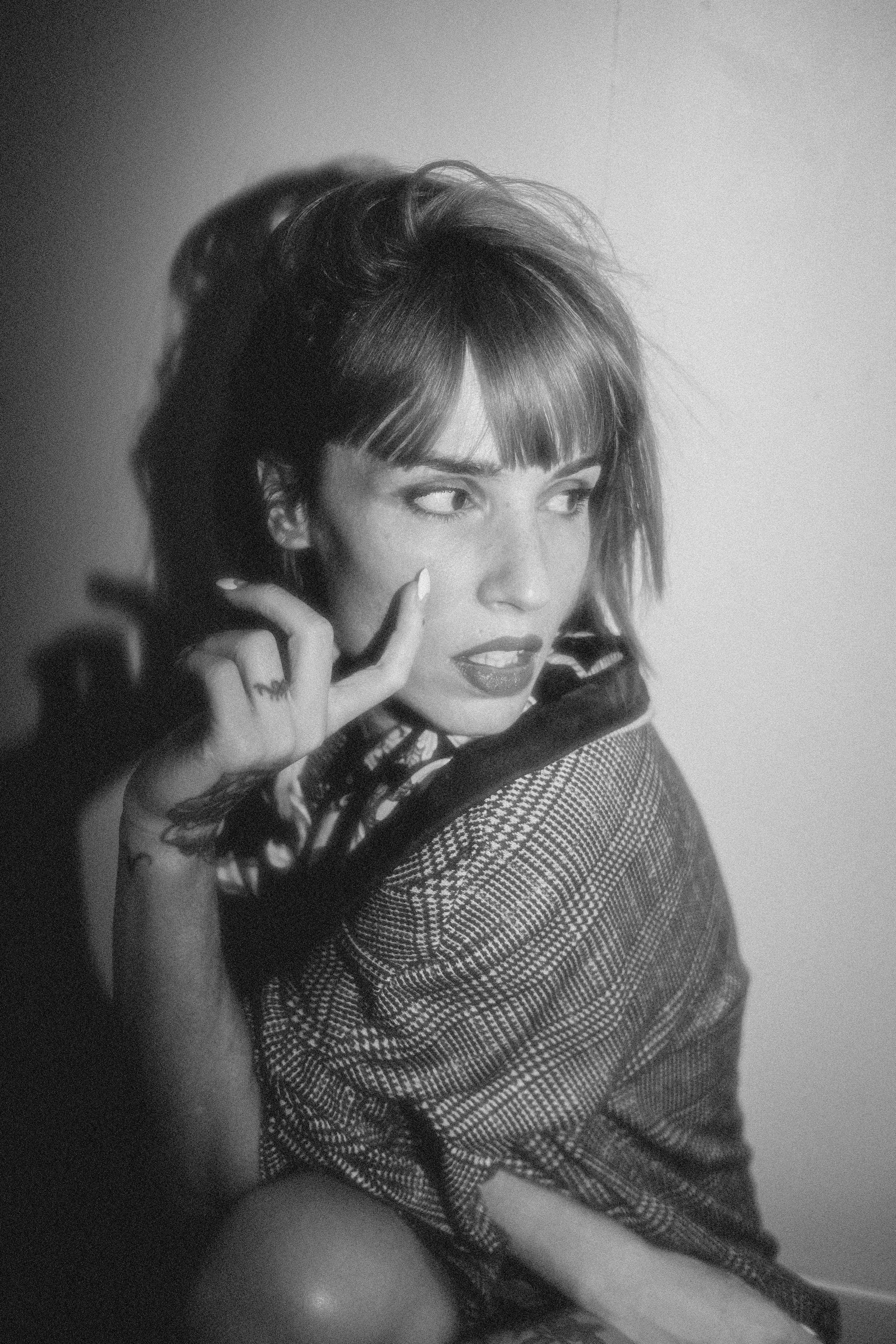 Stylish retro portrait of a woman in plaid jacket with tattoos, Montréal.