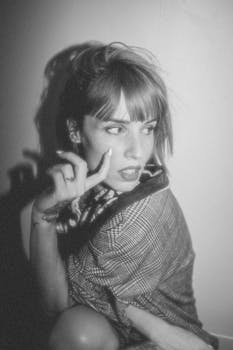 Stylish retro portrait of a woman in plaid jacket with tattoos, Montréal.