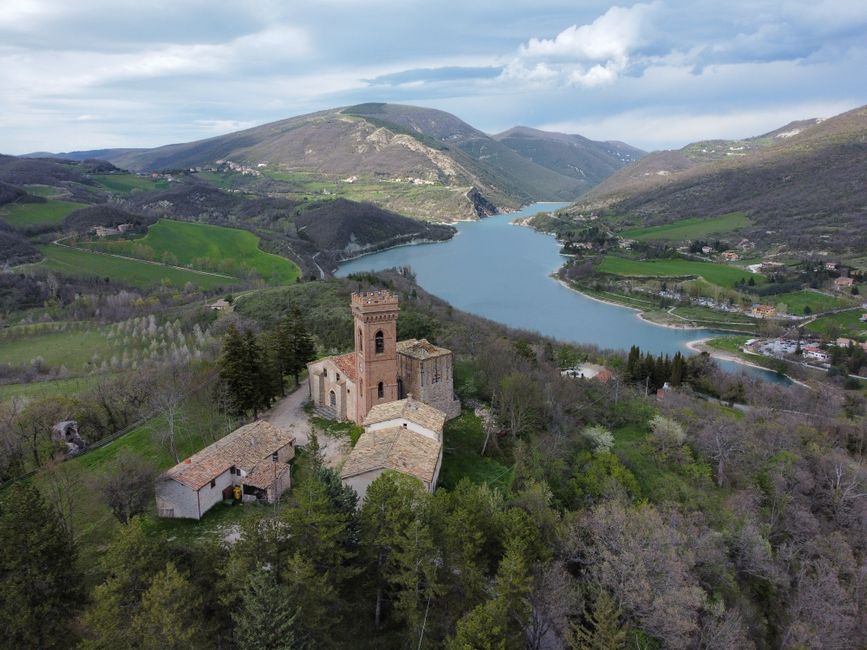 Incredible Helicopter Flight Over Mount Etna Review: Europe's Most Spectacular Volcanic Adventure Review 2026 - Scenic aerial view of a historic castle on a hill overlooking a beautiful lake and lush valley.