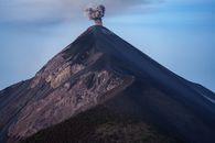 Stunning view of the active Volcán de Fuego emitting smoke against a morning sky in Guatemala.
