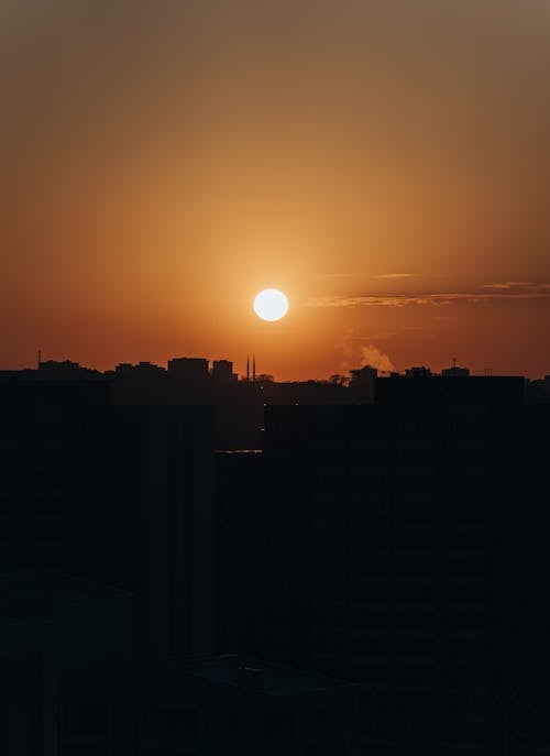 Free Outline of City Buildings in the Light of the Setting Sun Stock Photo