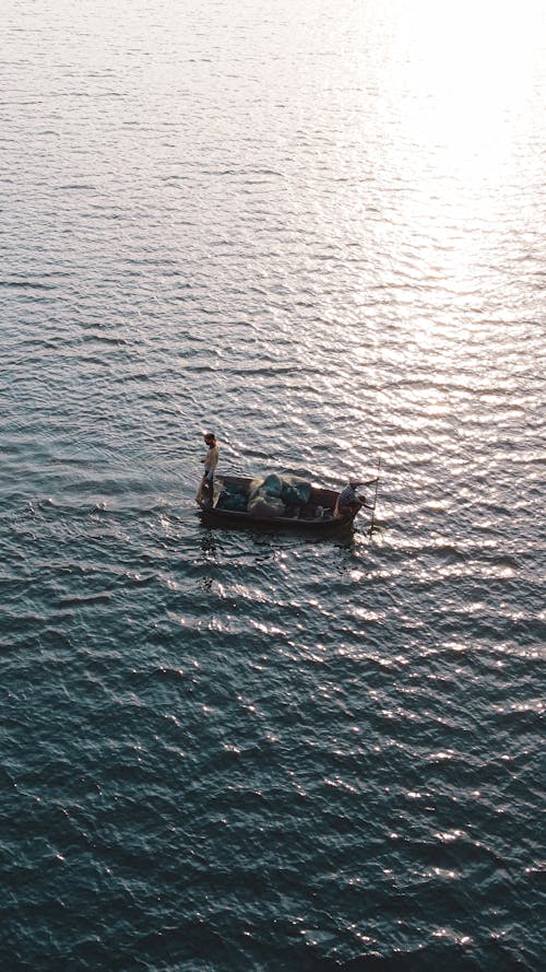 Aerial View of Fishermen Sailing on the Sea in a Small Boat