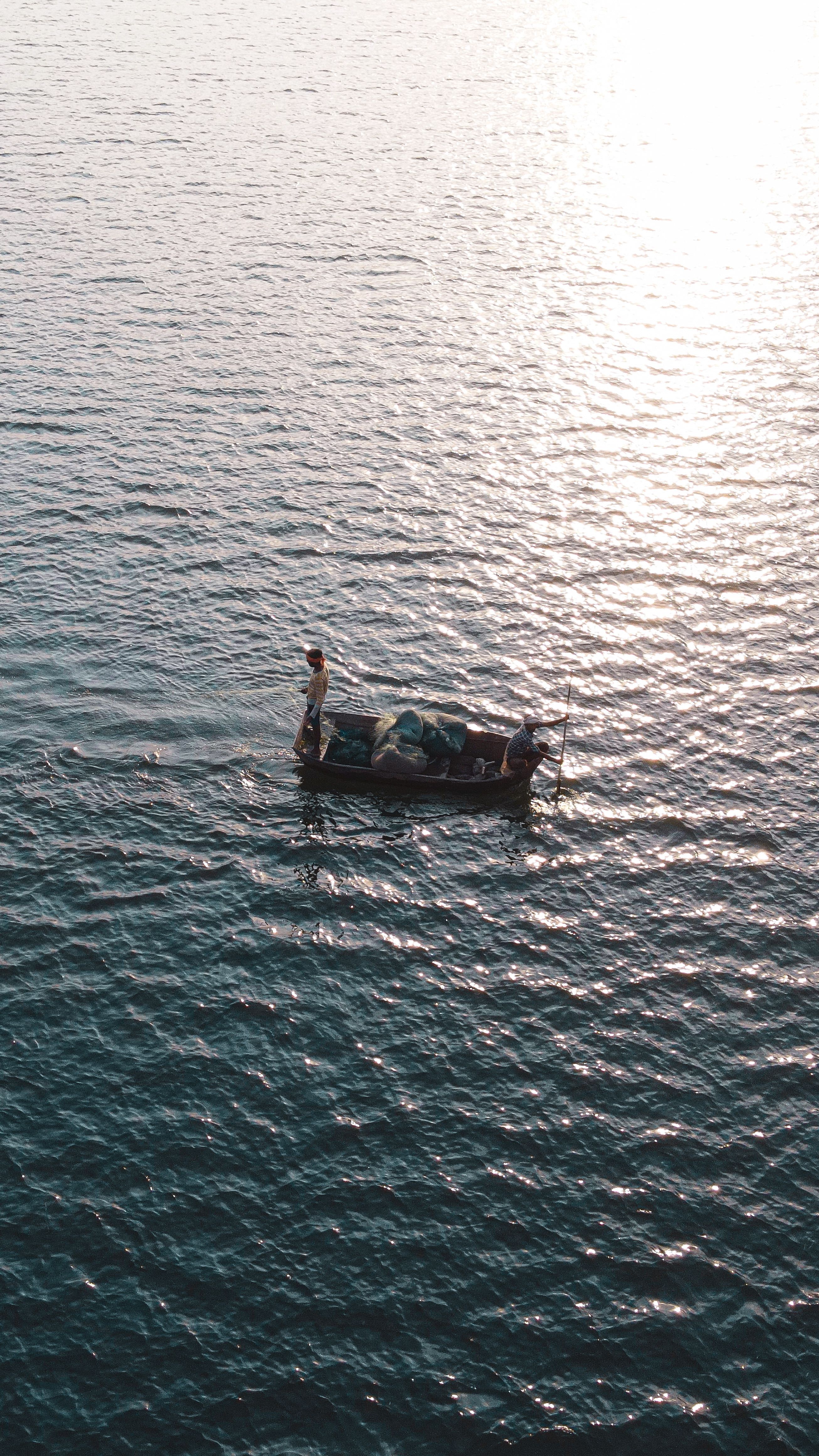 Aerial View of Fishermen Sailing on the Sea in a Small Boat