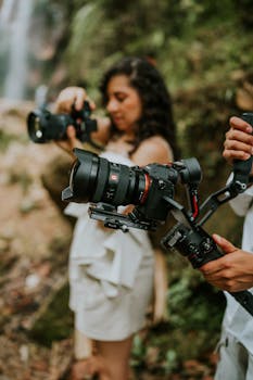 Two photographers capturing nature shots with advanced camera equipment outdoors.