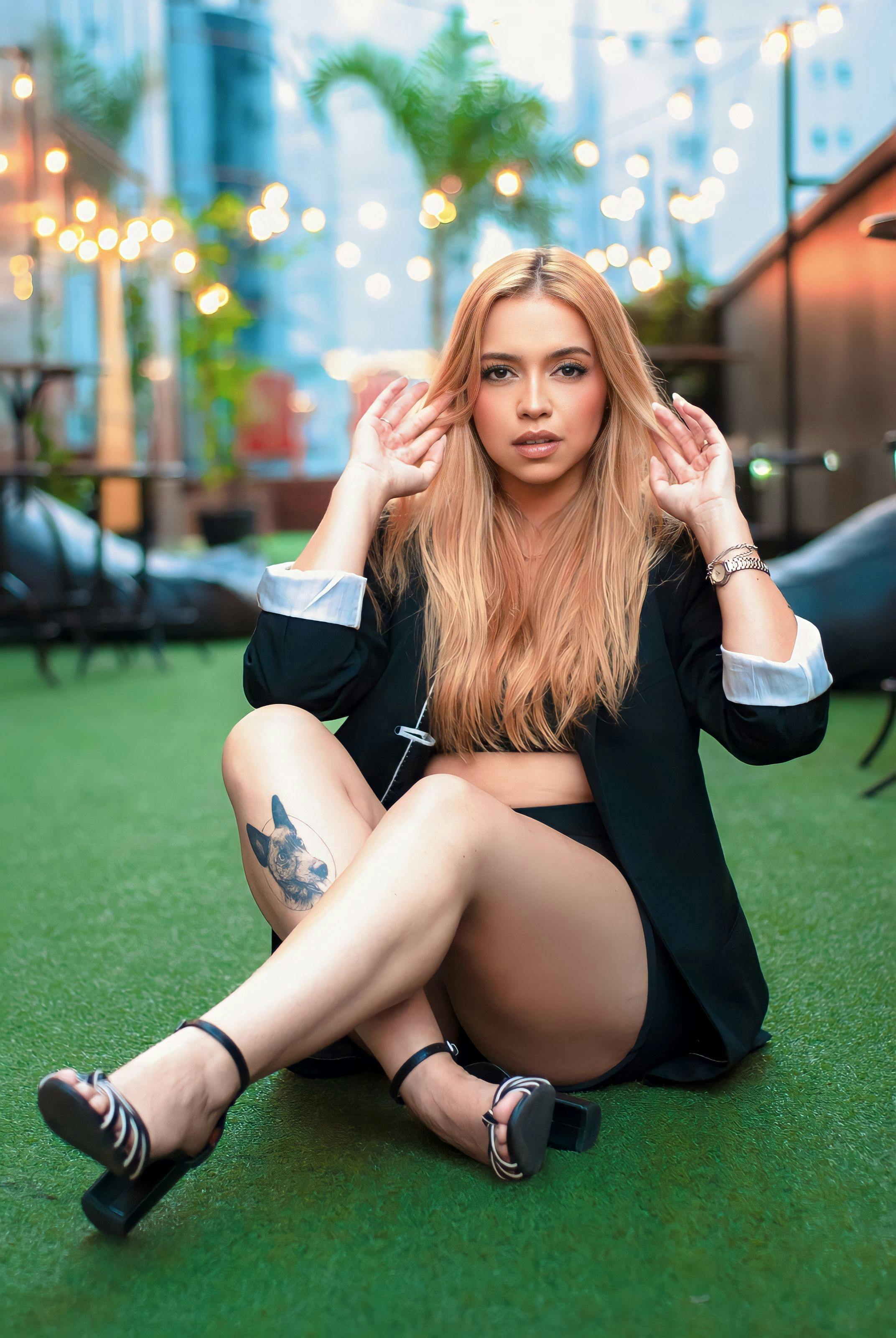 Young woman with blonde hair posing stylishly outdoors, capturing a modern fashion essence.