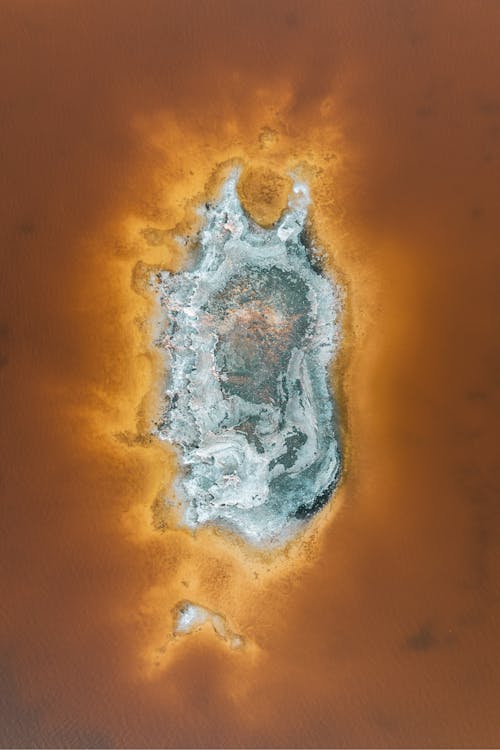 An aerial view of a small island with a large body of water