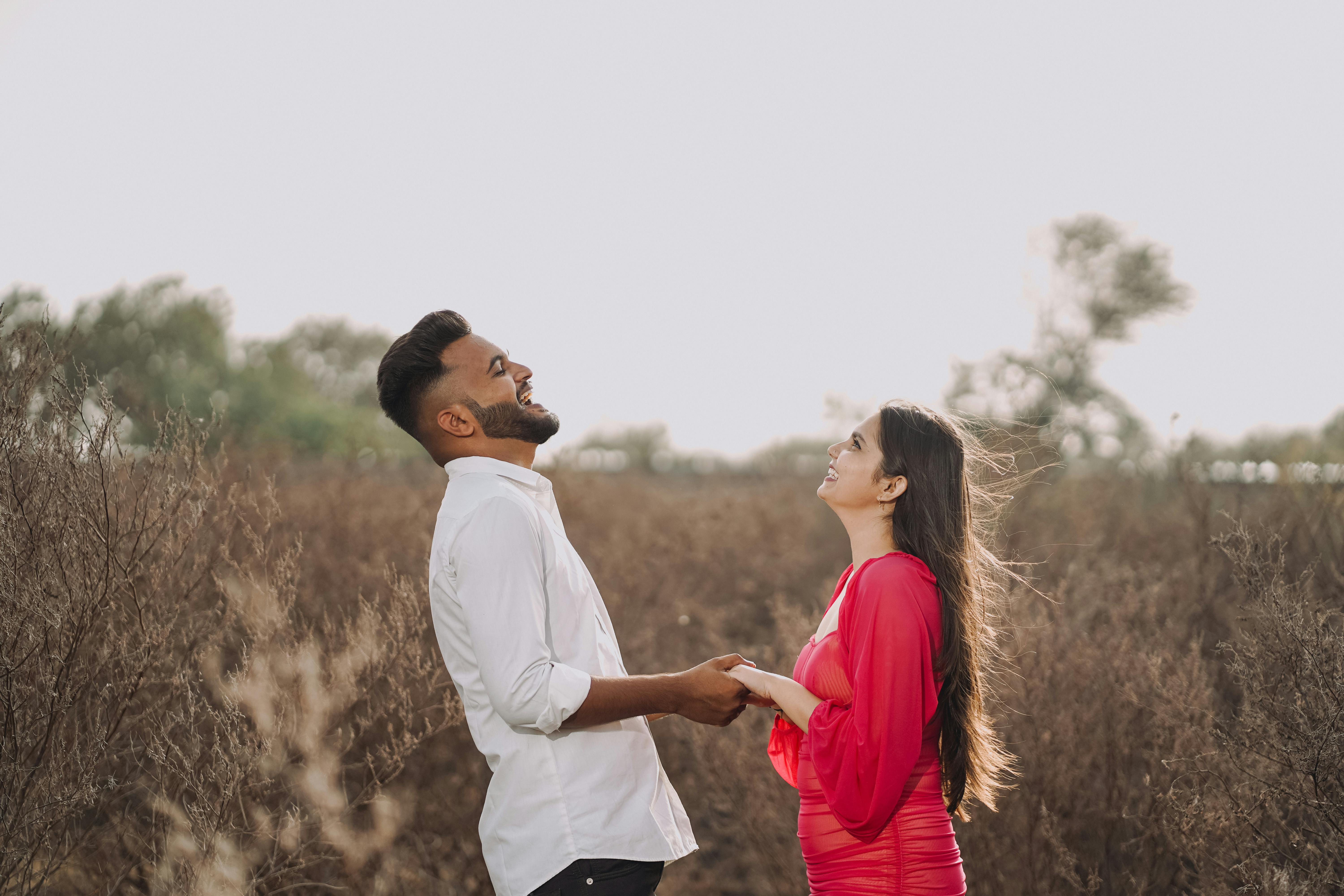 young couple holding hands and laughing