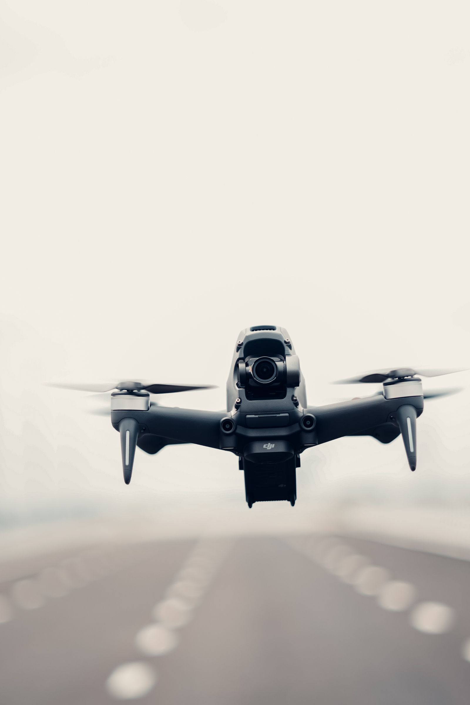 Modern unmanned aircraft flying above a road