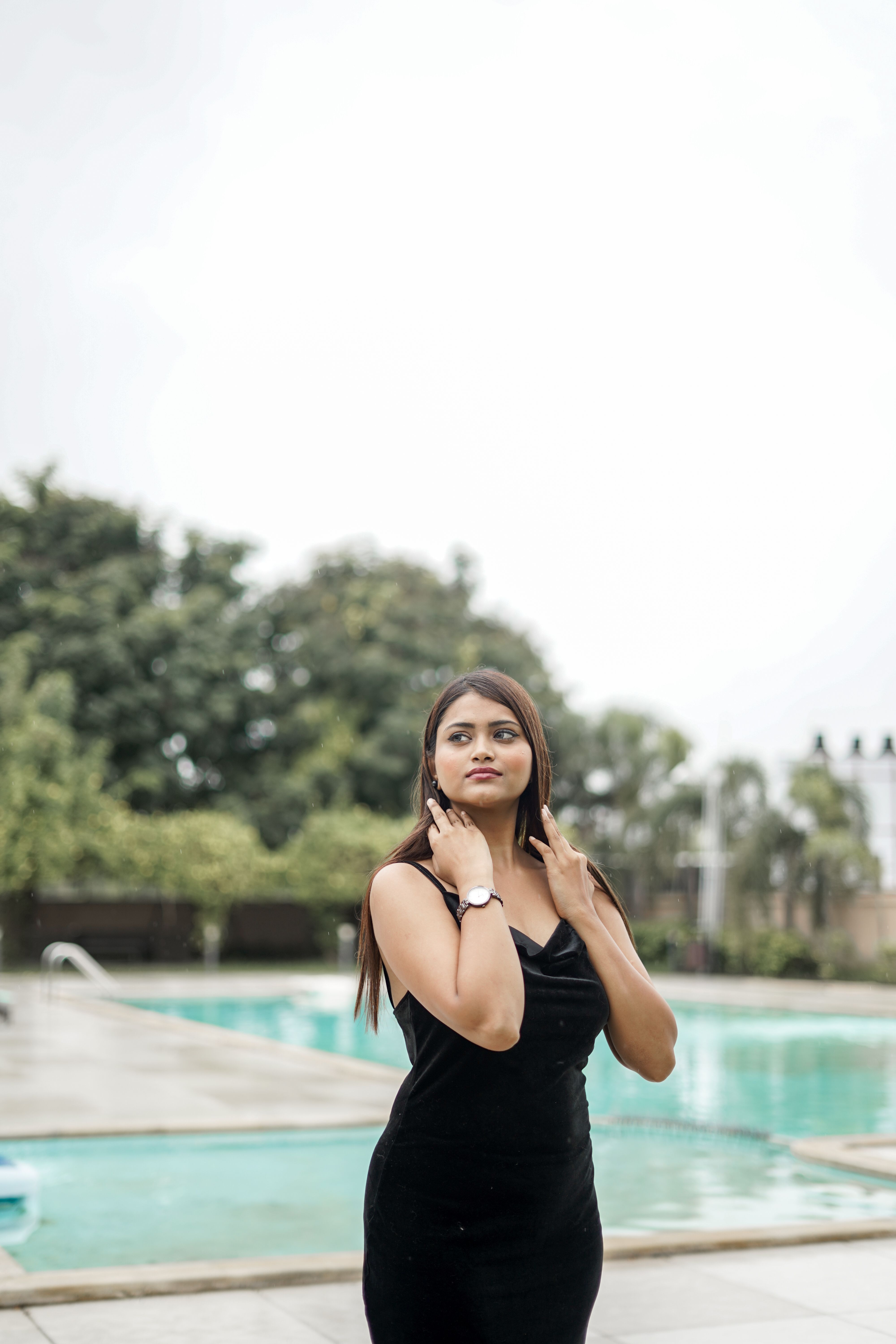 Young Woman in a Black Dress Standing by the Swimming Pool  Free Stock  Photo