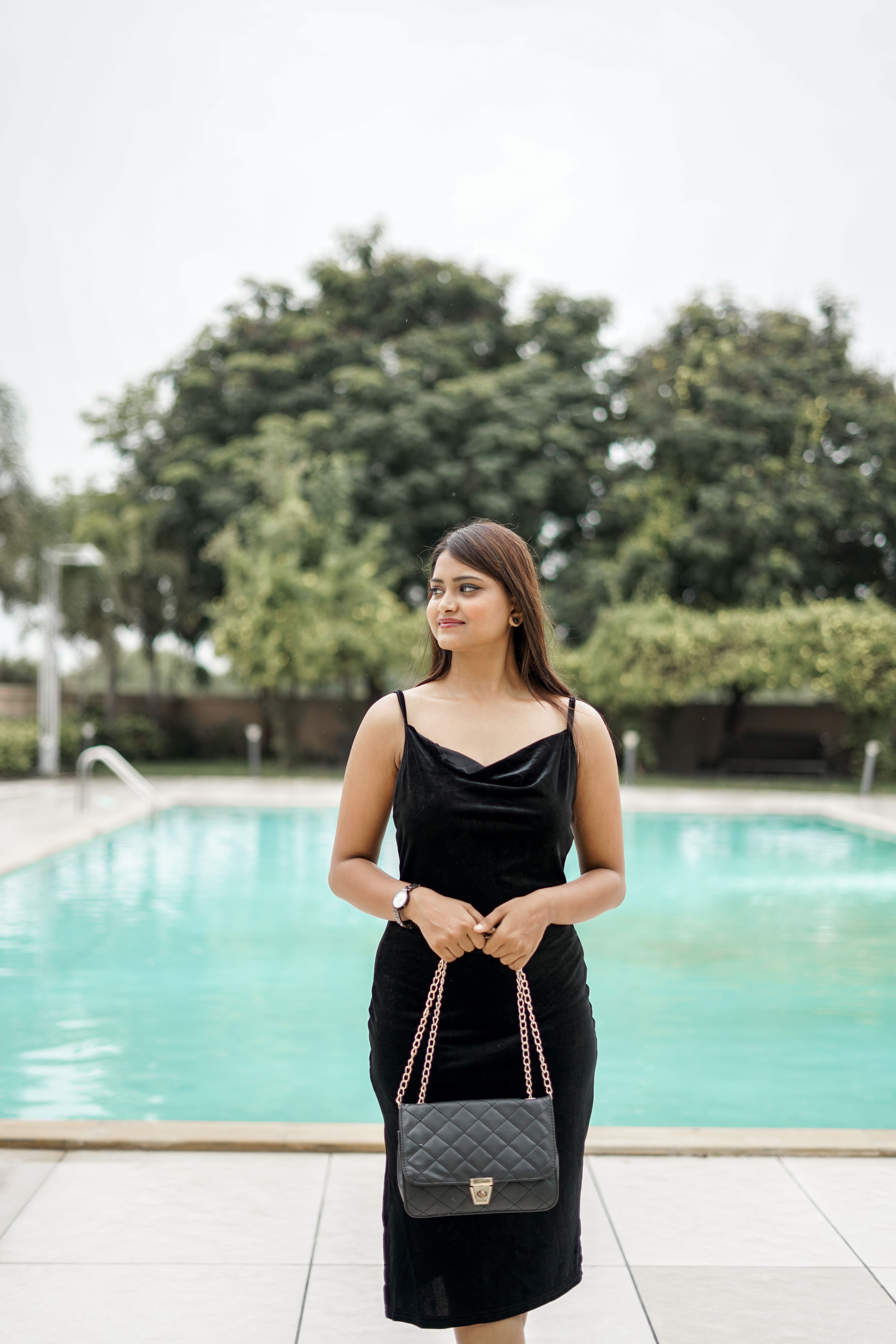 Young Woman in a Black Dress Standing by the Swimming Pool  Free Stock  Photo