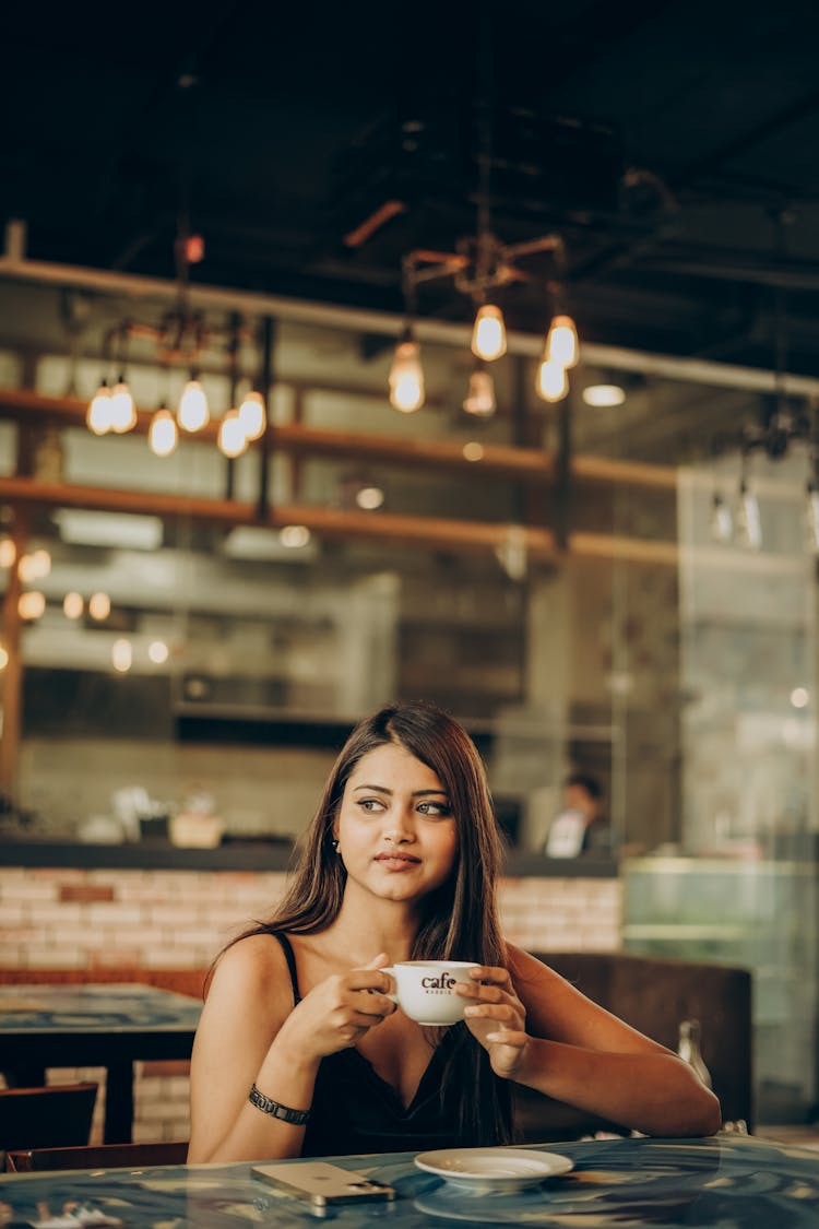 Smiling Girl With Coffee In Cafe