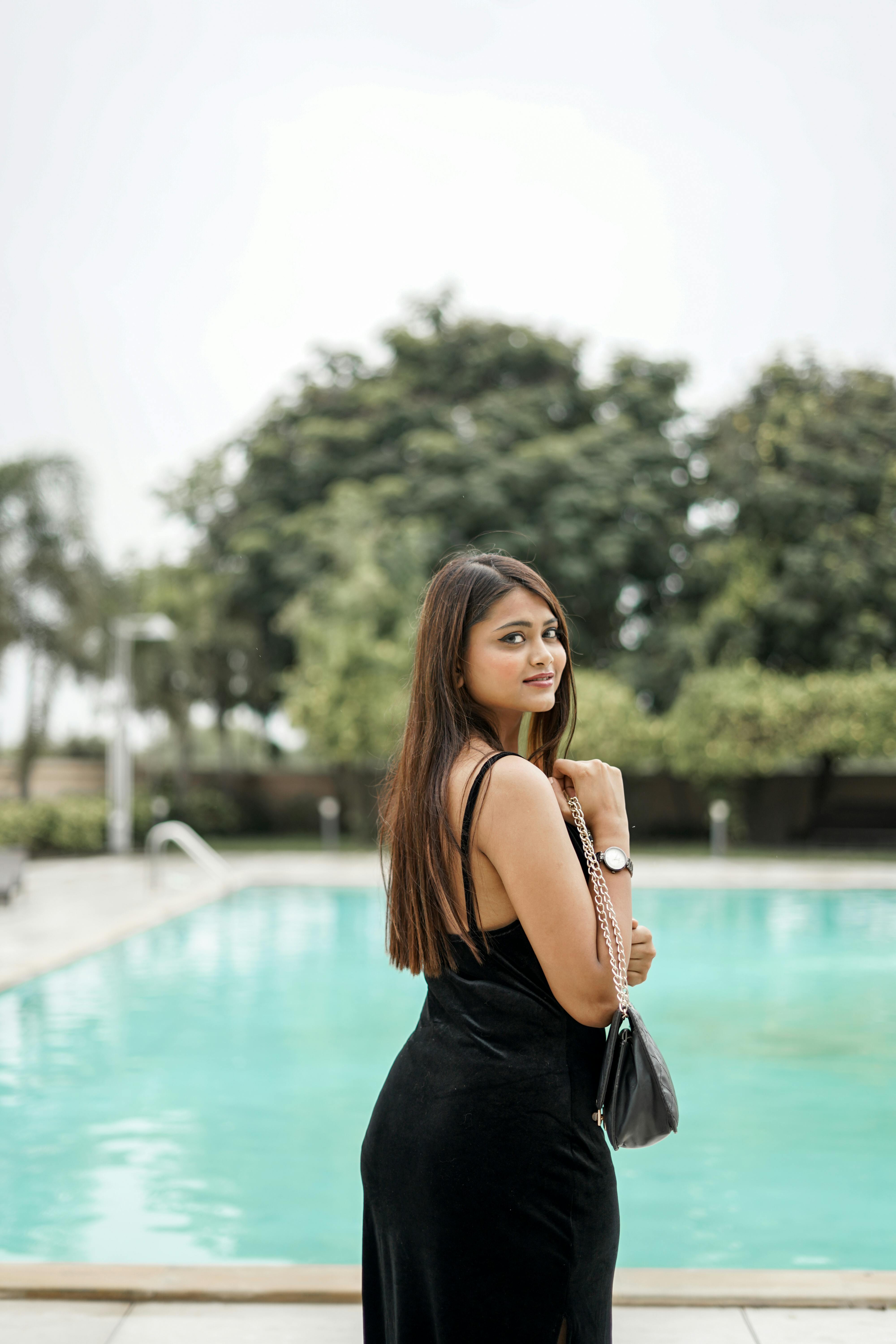 Girl posing in modern swimming pool with clear glass wall in resort and spa  hotel. Travel and vacation Stock Photo | Adobe Stock