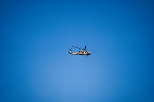 Military Helicopter against Blue Sky