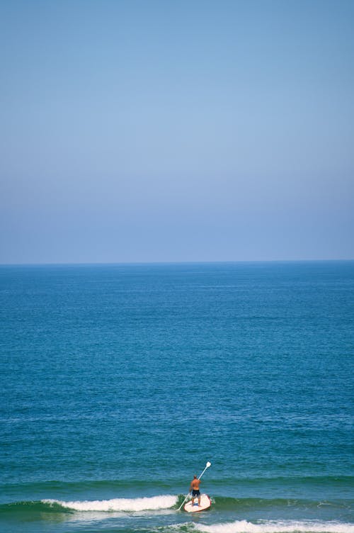 Man on Paddle Board on Sea Shore