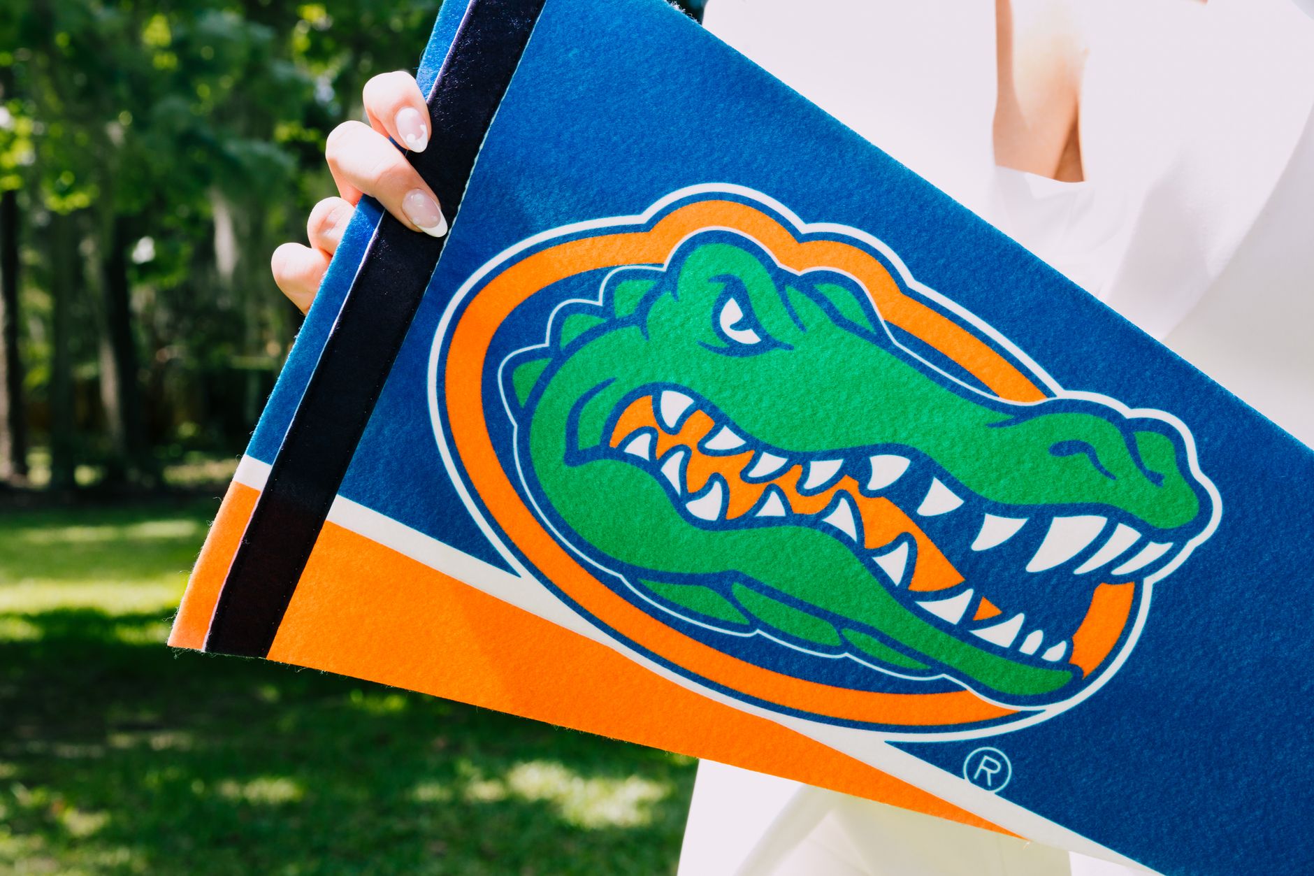 Hand holding Florida Gators team banner symbolizing team spirit and sports enthusiasm outdoors. — Prairie View A&M in Florida