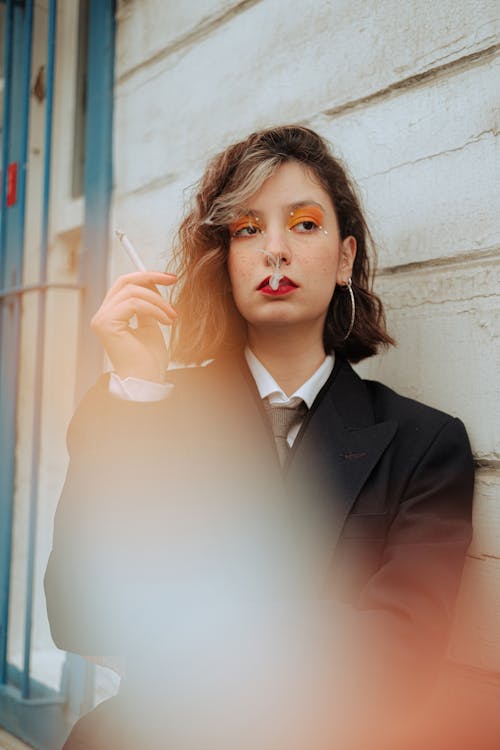 Smoking Woman near Wooden Wall