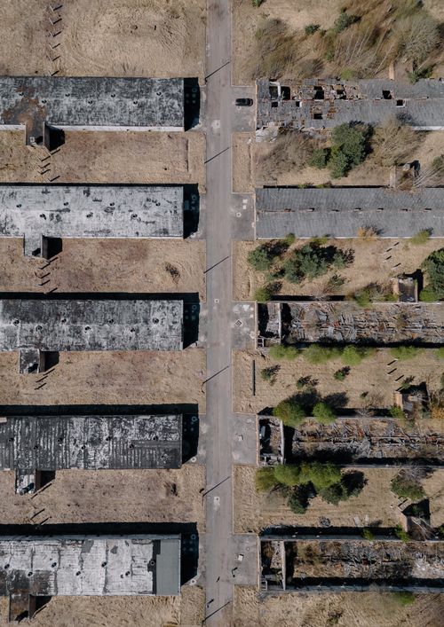 Free Explore the aerial perspective of abandoned buildings in Zaķumuiža, Latvia, showcasing decay and nature. Stock Photo