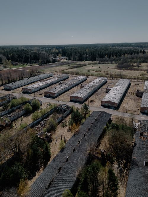 Free Discover the abandoned barracks in Zaķumuiža, Latvia, captured from above, showcasing historical military architecture amidst nature. Stock Photo