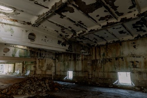 Free Explore the eerie interior of an abandoned industrial building, featuring peeling paint and ruins. Stock Photo