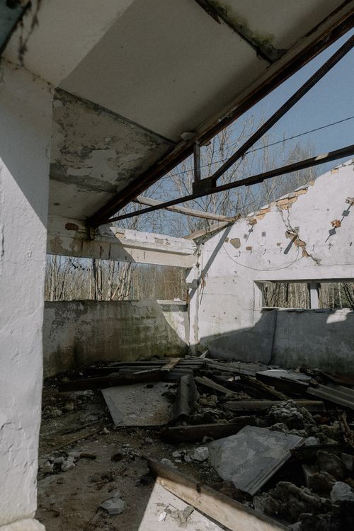 Free Interior of a dilapidated building with debris and natural light streaming in. Stock Photo
