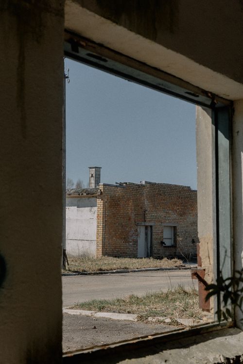 Free View through a window frame of an abandoned building in urban decay. Stock Photo