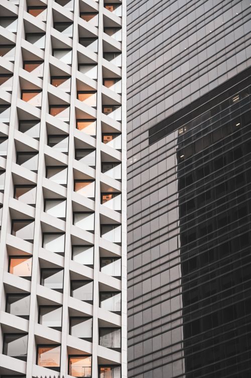 Free A close-up of modern skyscrapers with glass and geometric designs, showcasing urban architecture. Stock Photo