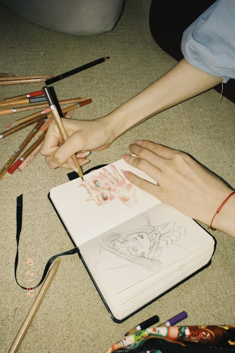 Woman Hands Drawing In Notebook