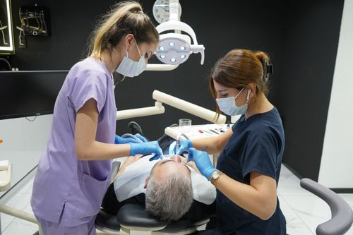 Free Dentists working on a patient in a modern Istanbul clinic, showcasing professional dental care. Stock Photo