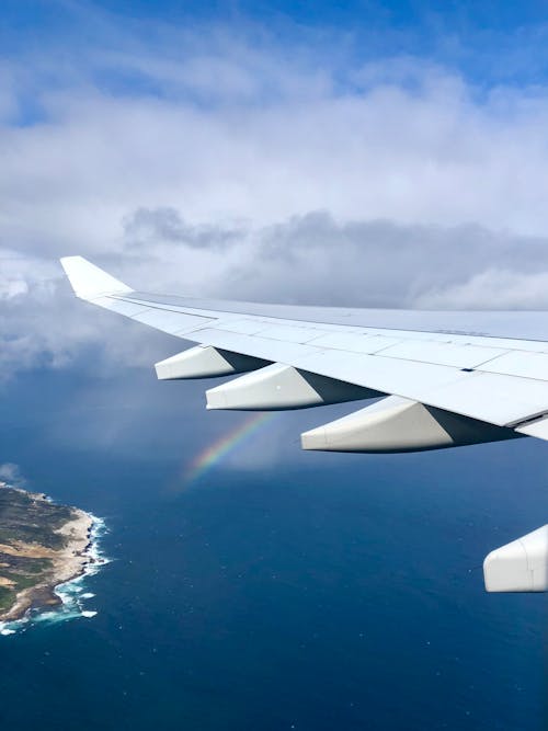 Free Airplane Wing With Rainbow Stock Photo