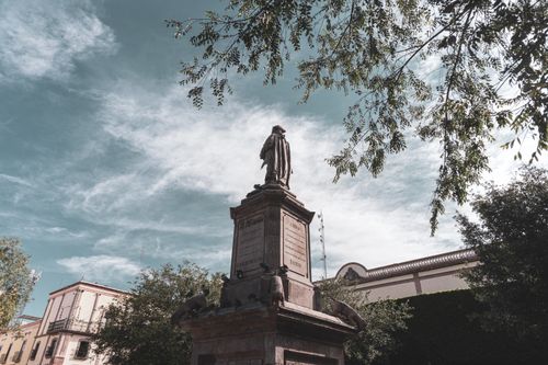 Free Statue in Santiago de Querétaro, Mexico, surrounded by greenery under a vibrant sky. Stock Photo