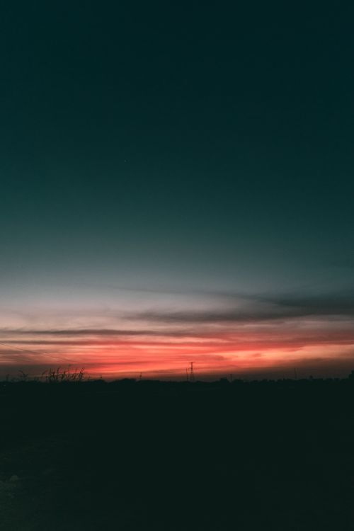 Free Capture the stunning, deep hues of a sunset over fields in Pedro Escobedo, Mexico. Stock Photo