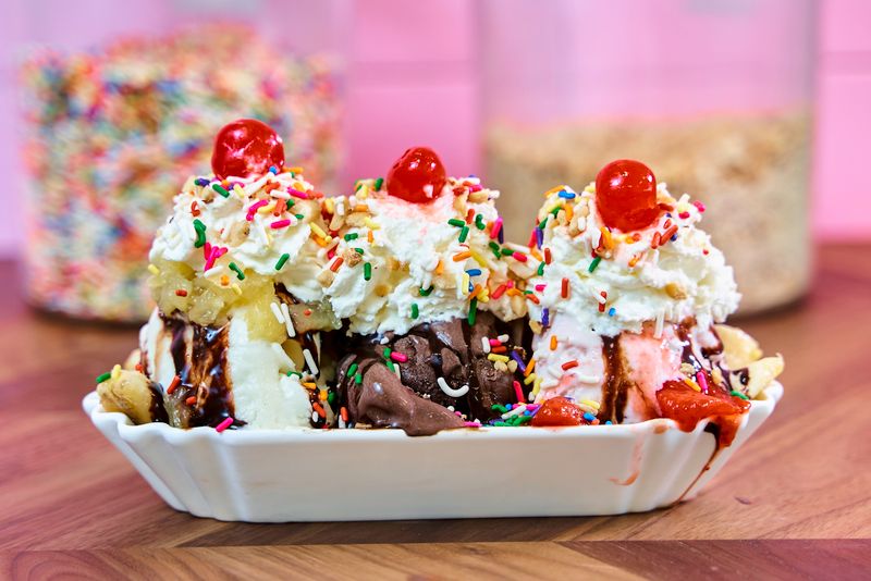 Ice cream topped with sprinkles and fresh fruit on a sundae bar