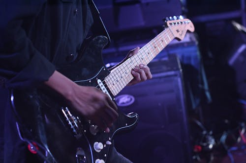 Free Person Using Black Fender Stratocaster Stock Photo