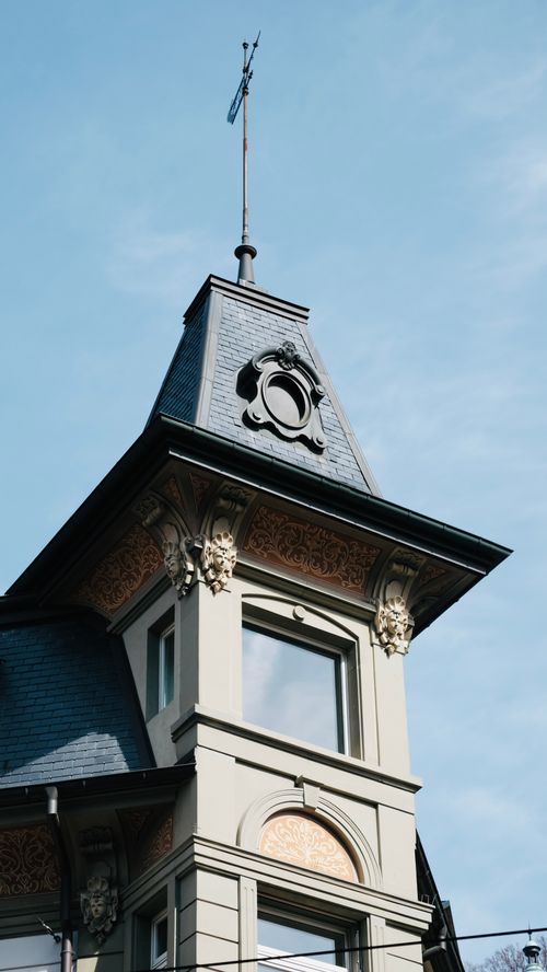 Free A detailed view of an ornate architectural tower with clear blue sky background. Stock Photo