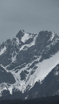 Majestic snow-covered mountain under overcast sky, perfect for winter landscapes.