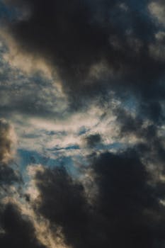 A moody sky filled with thick rain clouds showcasing a dramatic weather scene.