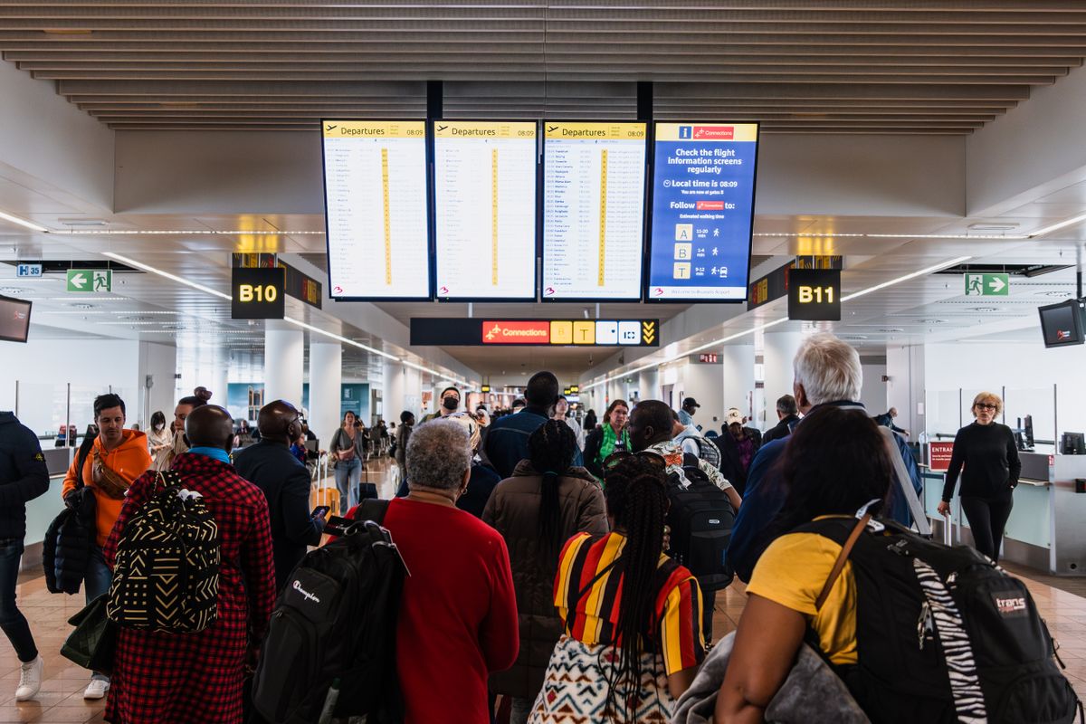 Busy airport terminal with travellers and baggage