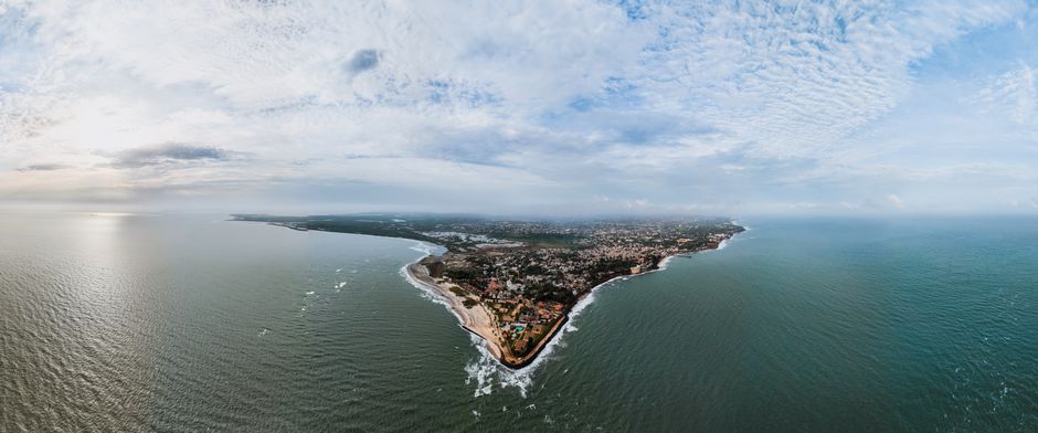 Stunning aerial view of Banjul, The Gambia's scenic coastline under a cloudy sky.