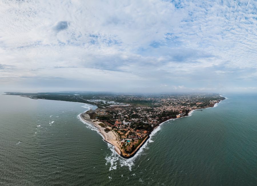 Stunning aerial view of Banjul, The Gambia's scenic coastline under a cloudy sky.