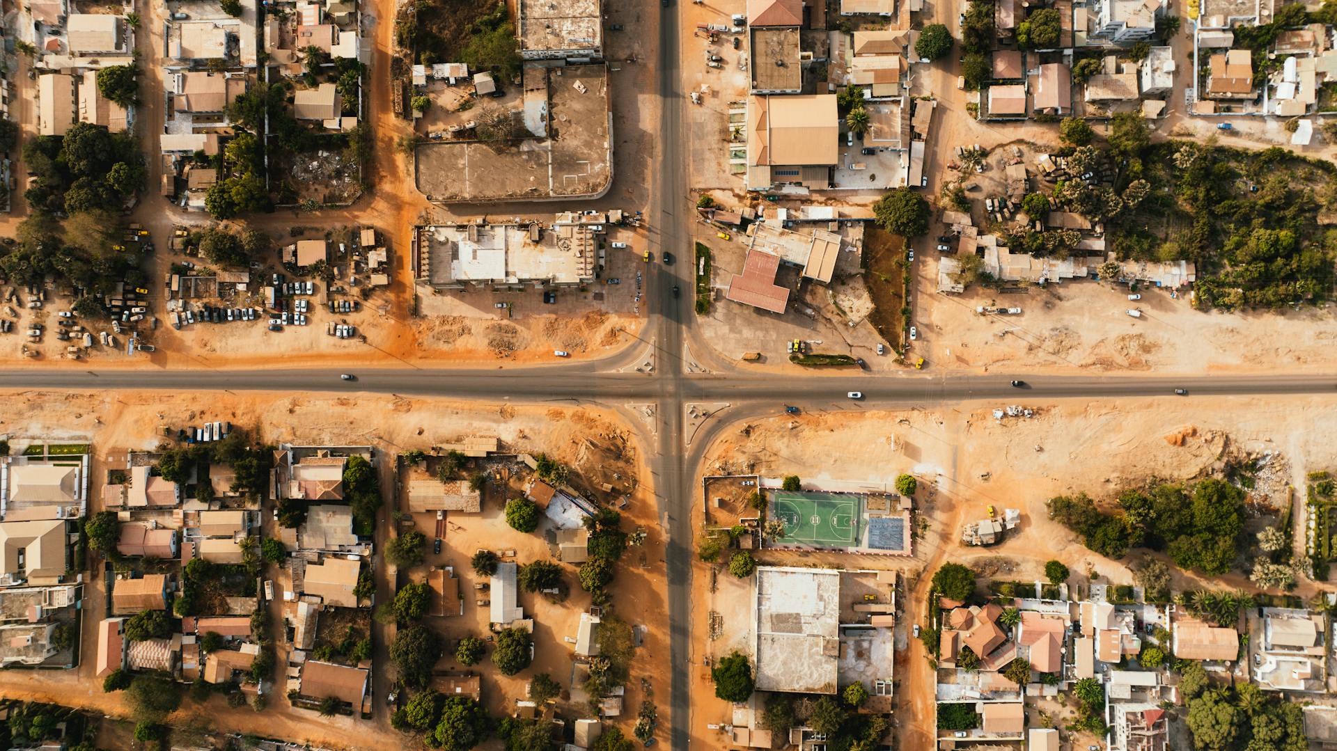 Aerial view of a city's grid layout with buildings and roads intersecting.