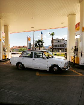 Classic car at a retro gas station in Marmaris, Türkiye, evoking nostalgia.