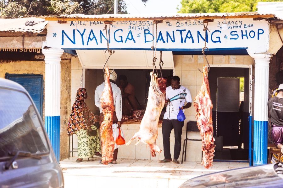 Butcher shop storefront with meat hanging on hooks