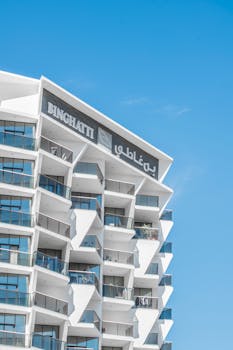 Contemporary Binghatti apartment building in Dubai under a clear blue sky.
